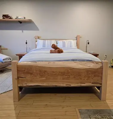 a teddy bear sitting on top of a bed at Madeira Park Oceanview Suites in Madeira Park