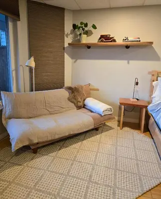 a couch sitting in a living room with a table at Madeira Park Oceanview Suites in Madeira Park