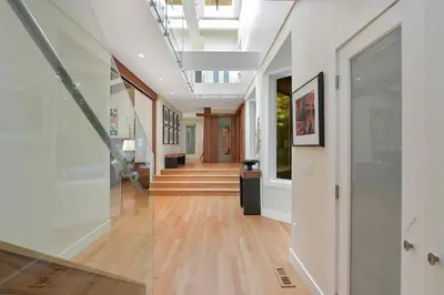 a hallway of a building with wood floors and a ceiling at Island Luxury Oceanside Estate by EMR Vacation Rentals in Saanichton