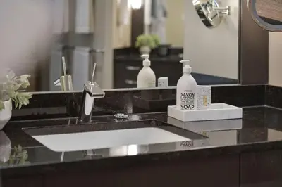 a bathroom counter with a sink and a mirror at Island Luxury Oceanside Estate by EMR Vacation Rentals in Saanichton
