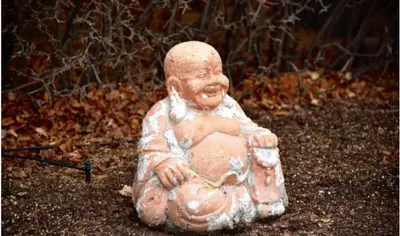 a statue of a man sitting on the ground at OFF CAMPUS UC Room in Calgary