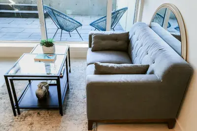 a living room with a couch and a glass table at Vibrant & Modern Loft-style Walkout Near LRT in Calgary