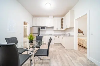 a kitchen and dining room with a glass table and chairs at William Place in Surrey