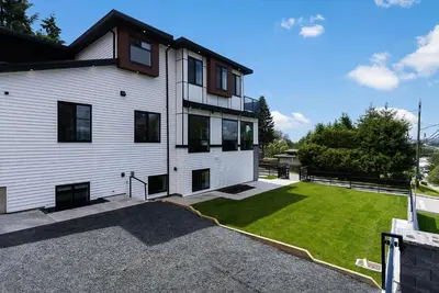 a large white house with a large yard at William Place in Surrey