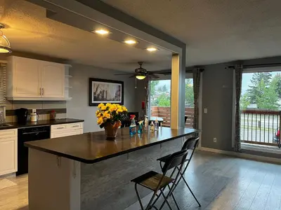 a kitchen with a large island with yellow flowers on it at hunter' s new home! in Calgary