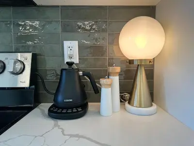 a kitchen counter with a blender and a lamp on it at The Evergreen House in Red Deer