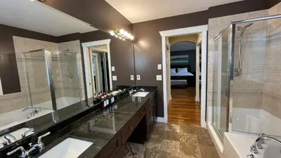 a bathroom with two sinks and a tub and a shower at Metropolitan Dream Stay with Saltwater Pool and Hot Tub in Surrey