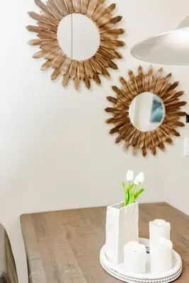 a dining room table with two mirrors on the wall at Canmore Mountain Views -3Beds-Ski Stay Deals in Canmore