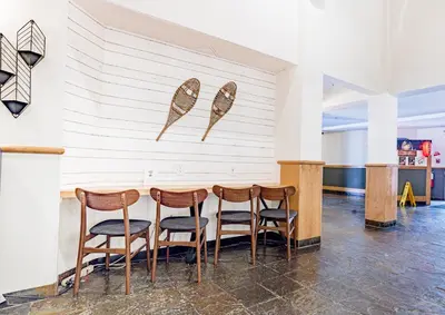 a table and chairs in a room with a wall at Canmore Mountain Views -3Beds-Ski Stay Deals in Canmore
