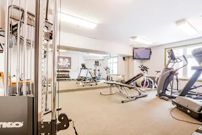 a gym with treadmills and exercise bikes at Canmore Mountain Views -3Beds-Ski Stay Deals in Canmore