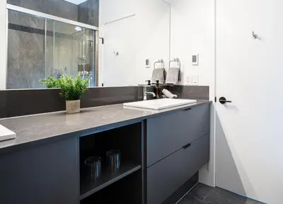 a bathroom with a sink and a mirror at Revy's Peak Condo - Hot Tub with View in Revelstoke