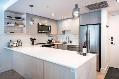 a kitchen with a white counter and a refrigerator at Rocky Ridge Getaway - Modern Getaway in Revelstoke in Revelstoke