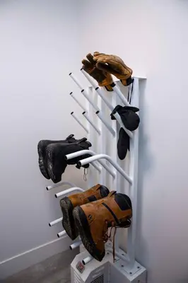 a rack with baseball gloves and gloves on it at Selkirk Staytion - Stylish Condo with Hot Tub in Revelstoke