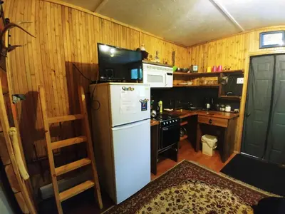 a kitchen with a white refrigerator and a microwave at Bone Creek Wilderness Retreat in Blue River
