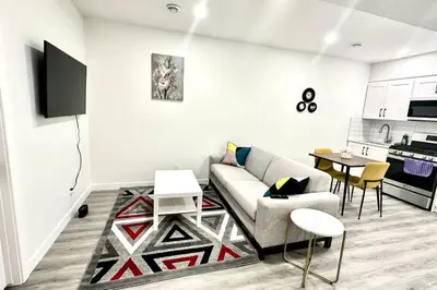 a living room with a couch and a table at The Cozy Nest in Calgary