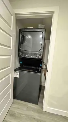 a small television sitting on top of a refrigerator at The Cozy Nest in Calgary