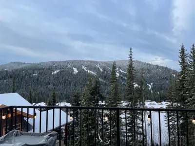 a balcony with a view of a snow covered mountain at New! Luxury, Top Floor, Ski in/Ski Out, Private Hot Tub and Mountain Views in Sun Peaks