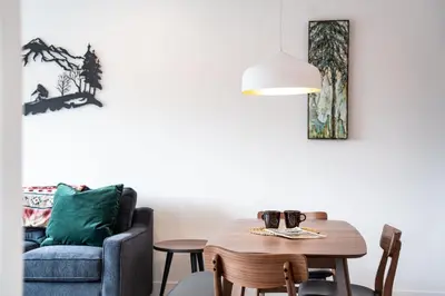 a living room with a table and a chair at Wildflower Retreat by Revelstoke Vacations in Revelstoke