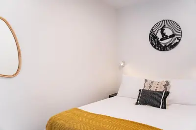 a bedroom with a bed and a clock on the wall at Wildflower Retreat by Revelstoke Vacations in Revelstoke