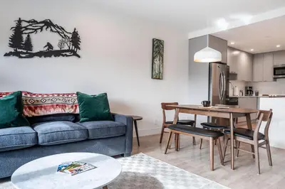 a living room with a couch and a table at Wildflower Retreat by Revelstoke Vacations in Revelstoke