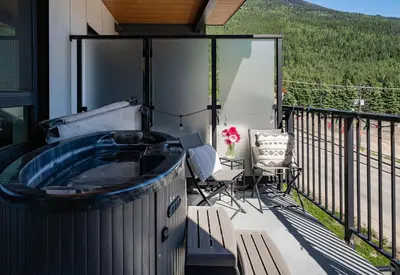 a hot tub on the balcony of a house at Wildflower Retreat by Revelstoke Vacations in Revelstoke