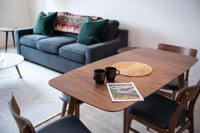 a living room with a wooden table and a couch at Wildflower Retreat by Revelstoke Vacations in Revelstoke