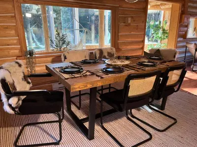 a dining room with a wooden table and chairs at Golden Cabin - Hot Tub - Games Barn - Theatre in Golden