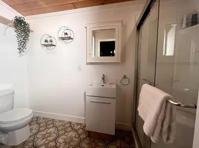 a bathroom with a toilet and a sink and a shower at Golden Cabin - Hot Tub - Games Barn - Theatre in Golden