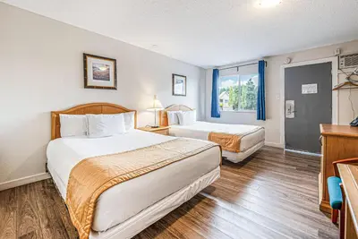 a hotel room with two beds and a window at Bluebird Motel in Nanaimo