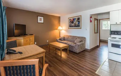 a living room with a couch and a table at Bluebird Motel in Nanaimo