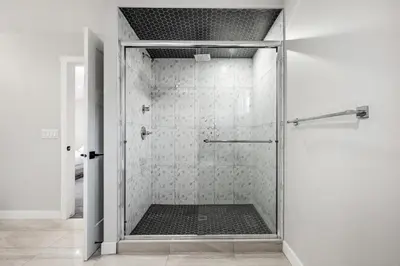 a shower with a glass door in a bathroom at Luxury Retreat For Large Groups in Calgary