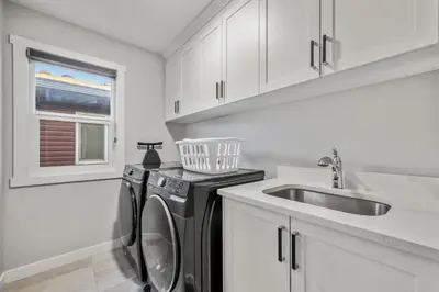 a kitchen with a washing machine and a sink at Luxury Retreat For Large Groups in Calgary