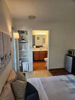 a living room with a bed and a kitchen at Pebbly Beach Suite in Snug Cove in Bowen Island