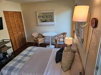 a bedroom with a bed and a table and chairs at Pebbly Beach Suite in Snug Cove in Bowen Island