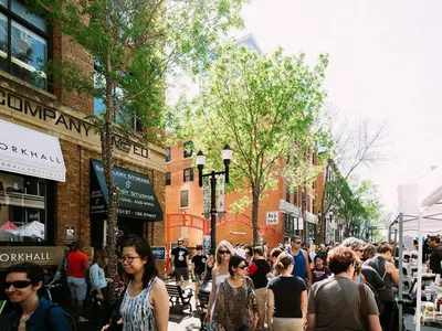 a crowd of people walking down a busy city street at Calming 1bedroom Units With Balcony And City View in Edmonton