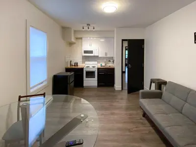 a living room with a couch and a glass table at Calming 1bedroom Units With Balcony And City View in Edmonton