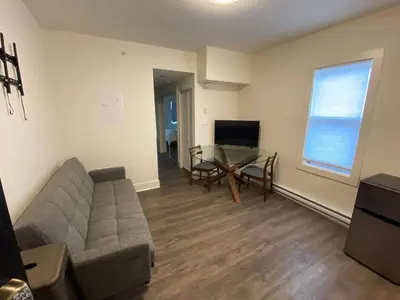 a living room with a couch and a table at Calming 1bedroom Units With Balcony And City View in Edmonton