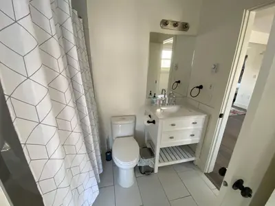 a bathroom with a toilet and a sink and a mirror at Historical Building 1br 1ba Walk To Rogers Place in Edmonton