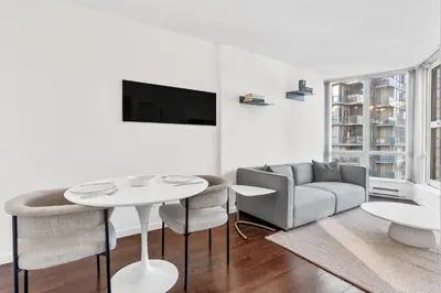a living room with a table and a couch at Downtown Luxury 1BR Coal Harbour in Vancouver