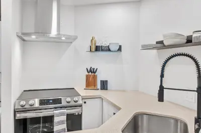 a kitchen with a sink and a stove at Downtown Luxury 1BR Coal Harbour in Vancouver