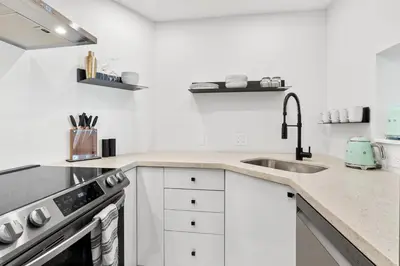 a white kitchen with a sink and a stove at Downtown Luxury 1BR Coal Harbour in Vancouver