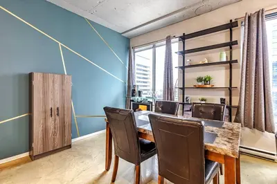 a dining room with a table and chairs at Industrial-Style Cityscape 1 Bedroom Loft in Edmonton