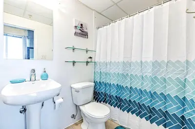 a bathroom with a white toilet and a sink at Industrial-Style Cityscape 1 Bedroom Loft in Edmonton