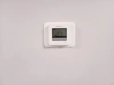 a white clock hanging on a white wall at Deluxe 2 bedroom suite with*Netflix/Cable/Prime in Edmonton
