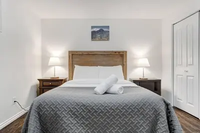 a bedroom with a large bed with two night stands at Coral Springs Lakefront Retreat in Calgary