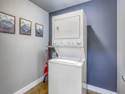a white washer and dryer in a room at Cozy 2BR Condo with King Bed and City Views in Calgary