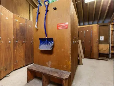 a wooden locker room with a bench and a door at Casa Creekside - Walk to Gondola, Shops, lakes! in Whistler