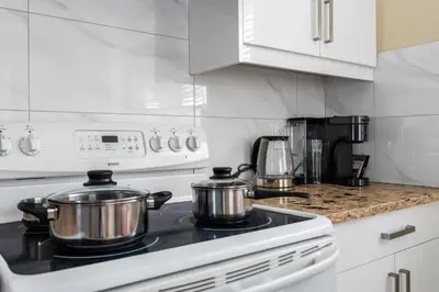 two pots on a stove in a kitchen at Three bedrooms new laneway house near public transit & FIFA training site in Vancouver