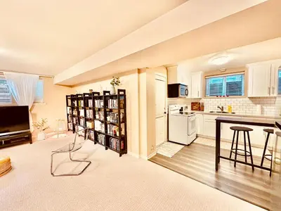 a kitchen with white cabinets and a table and chairs at Scorpio House Langley ROOM B in Langley