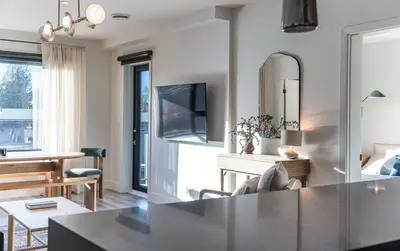 a living room with a kitchen and a dining room at Snowed Inn - Stunning 3 Bedroom Condo in Revelstoke